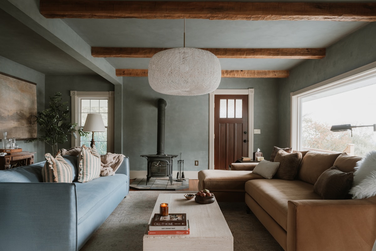 small sitting room with brass sconces and dried herbs on the mantel